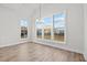 Bright dining area with large windows offering views, hardwood floors, and modern chandelier at 683 Summitt Hill Way, Cumming, GA 30040