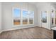 Bright dining area with large windows offering views, hardwood floors, and modern chandelier at 683 Summitt Hill Way, Cumming, GA 30040