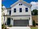Charming new construction home with gray garage door, covered front porch, and white siding at 683 Summitt Hill Way, Cumming, GA 30040