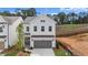 Charming two-story home with white siding, a gray garage door, and a neatly manicured front yard at 683 Summitt Hill Way, Cumming, GA 30040