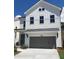 Charming new construction home with gray garage door, covered front porch, and white siding at 683 Summitt Hill Way, Cumming, GA 30040
