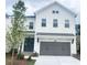 Charming two-story home with a gray attached garage, manicured lawn, and green front door at 683 Summitt Hill Way, Cumming, GA 30040