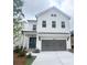 Two-story home with white exterior, gray garage door, and well-maintained lawn at 683 Summitt Hill Way, Cumming, GA 30040