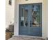 This home features a set of charming blue double front doors at 683 Summitt Hill Way, Cumming, GA 30040