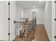 Upstairs hallway featuring hardwood floors, and a wooden staircase at 683 Summitt Hill Way, Cumming, GA 30040