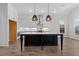 Modern kitchen featuring an island, pendant lighting, and white cabinets at 683 Summitt Hill Way, Cumming, GA 30040