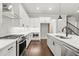 Modern kitchen showcasing stainless steel appliances, quartz countertops, and white cabinets at 683 Summitt Hill Way, Cumming, GA 30040