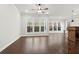 Spacious living area featuring hardwood flooring and large windows overlooking the backyard at 683 Summitt Hill Way, Cumming, GA 30040