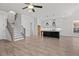 Spacious living area with wood-look flooring and a view into the open kitchen at 683 Summitt Hill Way, Cumming, GA 30040