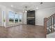 Cozy living room features wood-look floors, a fireplace, and plenty of natural light at 683 Summitt Hill Way, Cumming, GA 30040