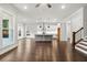 Open living space with hardwood floors, natural light, and a view into the contemporary kitchen at 683 Summitt Hill Way, Cumming, GA 30040
