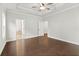 Bright main bedroom with wood floors, a ceiling fan, and access to the main bathroom at 683 Summitt Hill Way, Cumming, GA 30040