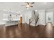 Bright open-concept living space with a modern kitchen, hardwood floors, and staircase at 683 Summitt Hill Way, Cumming, GA 30040