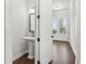 Stylish powder room with a modern pedestal sink, elegant mirror, and pristine white walls at 683 Summitt Hill Way, Cumming, GA 30040