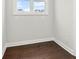 Small room with hardwood floors, white trim, and a window letting in natural light at 683 Summitt Hill Way, Cumming, GA 30040