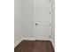 Small room with hardwood floors, white trim and a closed white door at 683 Summitt Hill Way, Cumming, GA 30040
