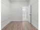 A well-organized walk-in closet with white shelving and access to an ensuite bathroom at 683 Summitt Hill Way, Cumming, GA 30040