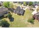 Aerial view showcases a spacious backyard, mature trees, and screened-in porch, providing outdoor enjoyment and relaxation at 755 Peninsula Overlook, Hampton, GA 30228