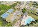 Aerial view showcasing community amenities, including tennis courts, a pool, playground, and parking, promoting active community at 755 Peninsula Overlook, Hampton, GA 30228