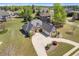 Aerial view of the home showcases its well-manicured lawn and large driveway, blending elegance with curb appeal at 755 Peninsula Overlook, Hampton, GA 30228