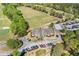 Aerial shot of the golf course showcasing the greens, trees, and clubhouse with surrounding parking at 755 Peninsula Overlook, Hampton, GA 30228