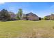 Large backyard featuring a well-maintained lawn and a view of the home's exterior at 755 Peninsula Overlook, Hampton, GA 30228