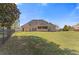 Spacious backyard featuring lush lawn, fence, and brick home exterior at 755 Peninsula Overlook, Hampton, GA 30228