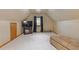Finished bonus room with a slanted ceiling, TV, a bench, and an arched window at 755 Peninsula Overlook, Hampton, GA 30228