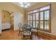 Dining area with modern table and chairs, hardwood floors, and large windows with plantation shutters at 755 Peninsula Overlook, Hampton, GA 30228