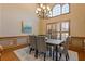 Formal dining room featuring a modern chandelier, wainscoting, and wooden shutters at 755 Peninsula Overlook, Hampton, GA 30228