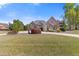 Lovely single-Gathering home with well-manicured lawn, mature trees, and charming curb appeal at 755 Peninsula Overlook, Hampton, GA 30228