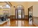 Grand foyer boasting hardwood floors, high ceilings, and an arched doorway at 755 Peninsula Overlook, Hampton, GA 30228