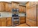 Kitchen featuring wood cabinets, stainless steel appliances and granite countertops at 755 Peninsula Overlook, Hampton, GA 30228