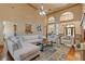 Open living area with hardwood floors, a cozy sectional, and a view of the entry at 755 Peninsula Overlook, Hampton, GA 30228