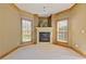 Carpeted sitting area with fireplace and large windows with natural light at 755 Peninsula Overlook, Hampton, GA 30228