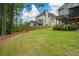 Spacious back yard featuring a well-maintained lawn, wooden privacy fence, and tiered deck at 1052 Secret Ne Trl, Sugar Hill, GA 30518