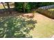 Large backyard with lush green grass and mature trees, offering ample space for recreation and relaxation at 1052 Secret Ne Trl, Sugar Hill, GA 30518
