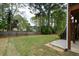 Expansive backyard featuring a well-kept lawn, mature trees, and a privacy fence, perfect for outdoor activities and relaxation at 1052 Secret Ne Trl, Sugar Hill, GA 30518