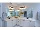 Bright bathroom with dual sinks, vanity, and an oversized mirror, providing an elegant and functional space at 1052 Secret Ne Trl, Sugar Hill, GA 30518