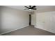 Simple bedroom with neutral carpet and wall colors, plus closet and hall access at 1052 Secret Ne Trl, Sugar Hill, GA 30518