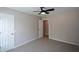 Neutral bedroom features neutral carpet, walls and trim, along with an adjoining door at 1052 Secret Ne Trl, Sugar Hill, GA 30518