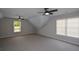 Spacious bonus room with neutral carpet, windows, and ceiling fans for added comfort at 1052 Secret Ne Trl, Sugar Hill, GA 30518