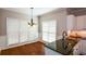 Sunlit breakfast nook features hardwood floors, a hanging chandelier, and large windows at 1052 Secret Ne Trl, Sugar Hill, GA 30518