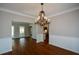 Open dining room with hardwood floors, chandelier, and a seamless transition to the kitchen at 1052 Secret Ne Trl, Sugar Hill, GA 30518