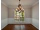 Dining area with hardwood floors, large window and an elegant chandelier at 1052 Secret Ne Trl, Sugar Hill, GA 30518