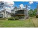 Rear view of the house featuring an expansive lawn and a two-story deck and screened in porch at 1052 Secret Ne Trl, Sugar Hill, GA 30518