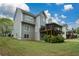 Home featuring ample windows, a tiered deck, and screened-in porch, situated on a green lawn at 1052 Secret Ne Trl, Sugar Hill, GA 30518