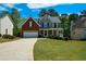 Beautiful home featuring a welcoming front porch, well-maintained lawn, and a two-car garage in a suburban neighborhood at 1052 Secret Ne Trl, Sugar Hill, GA 30518