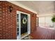 Charming front porch with brick accents, a wreath on the door, and a welcoming outdoor space at 1052 Secret Ne Trl, Sugar Hill, GA 30518