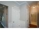 Hallway with access to basement and laundry room at 1052 Secret Ne Trl, Sugar Hill, GA 30518